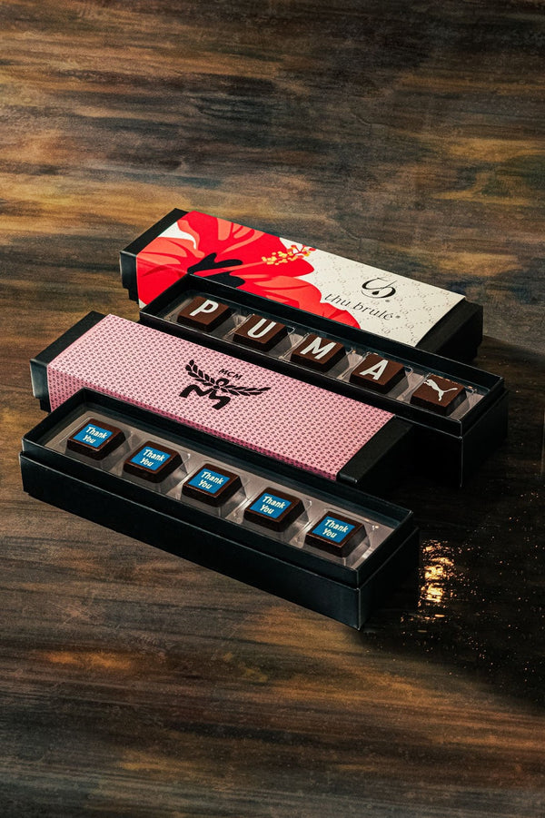 Four custom chocolate boxes with truffles on table — Compartés