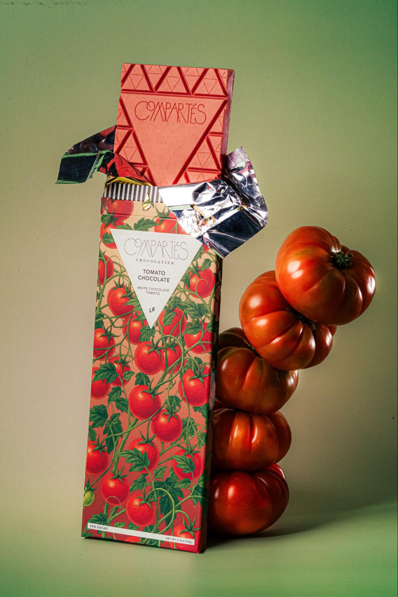 Tomato chocolate bar next to tower of tomatoes — Compartés