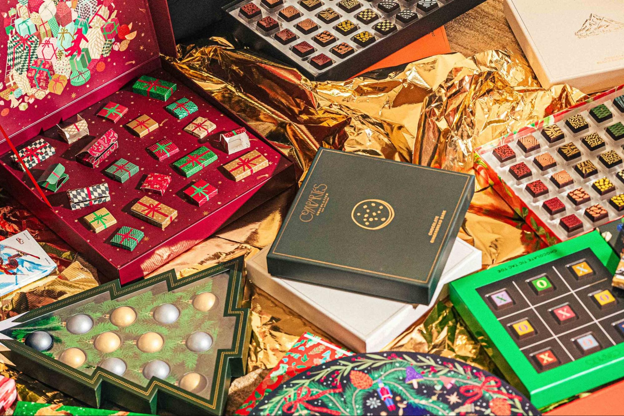 Assortment of Compartés holiday chocolate boxes on gold foil