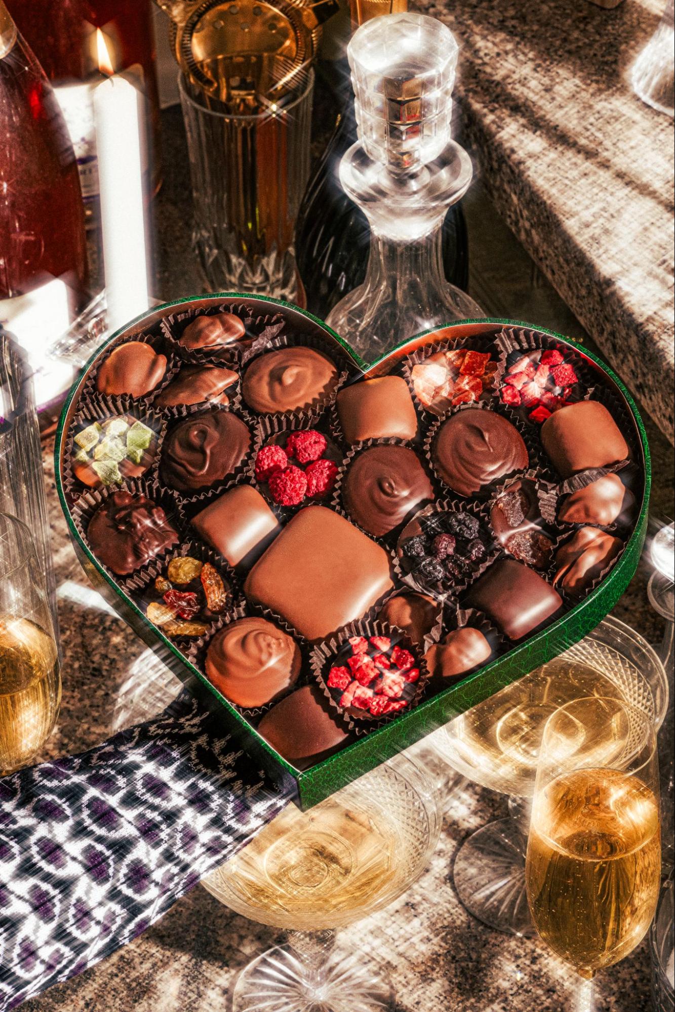 Best chocolate for Valentine’s Day featuring a heart-shaped box of gourmet assorted chocolates with fruit and dark chocolate truffles