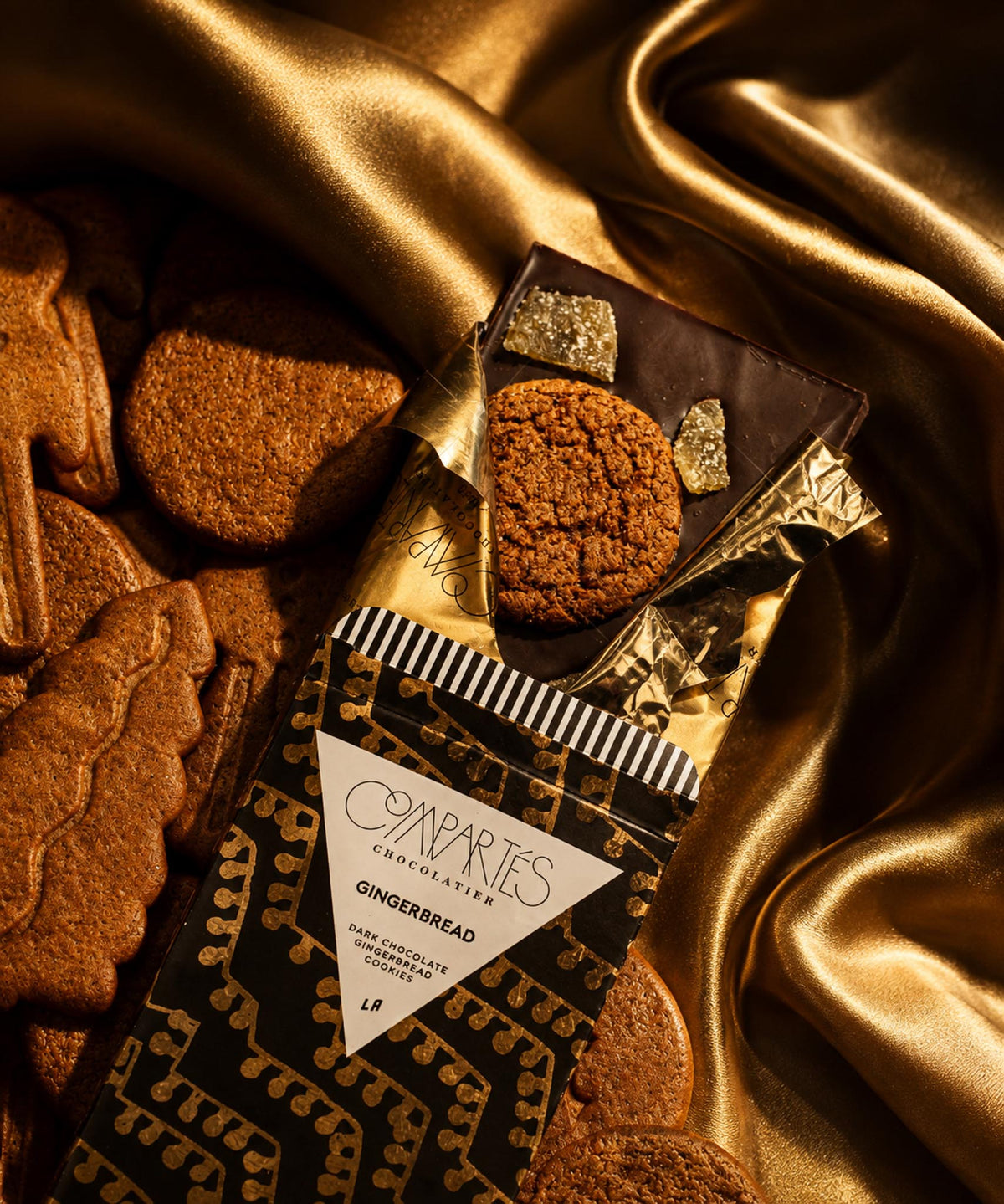 A holiday chocolate bar of dark chocolate with christmas gingerbread scattered across the top. Fancy chocolate bar and chocolate stocking stuffers for holiday gifts by Compartes Los Angeles.
