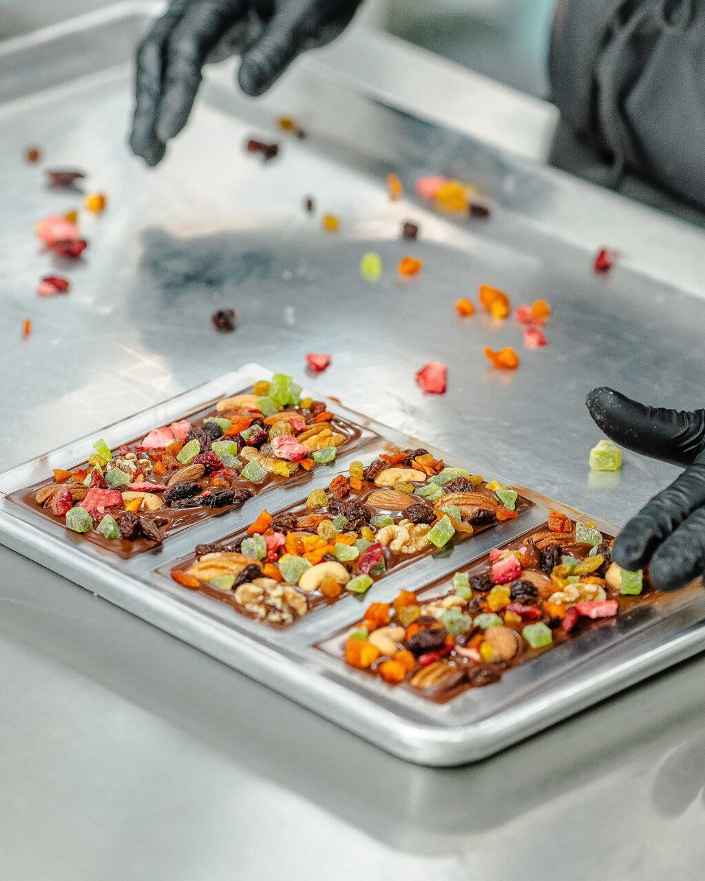 Compartés fruit and nut chocolate bar being made