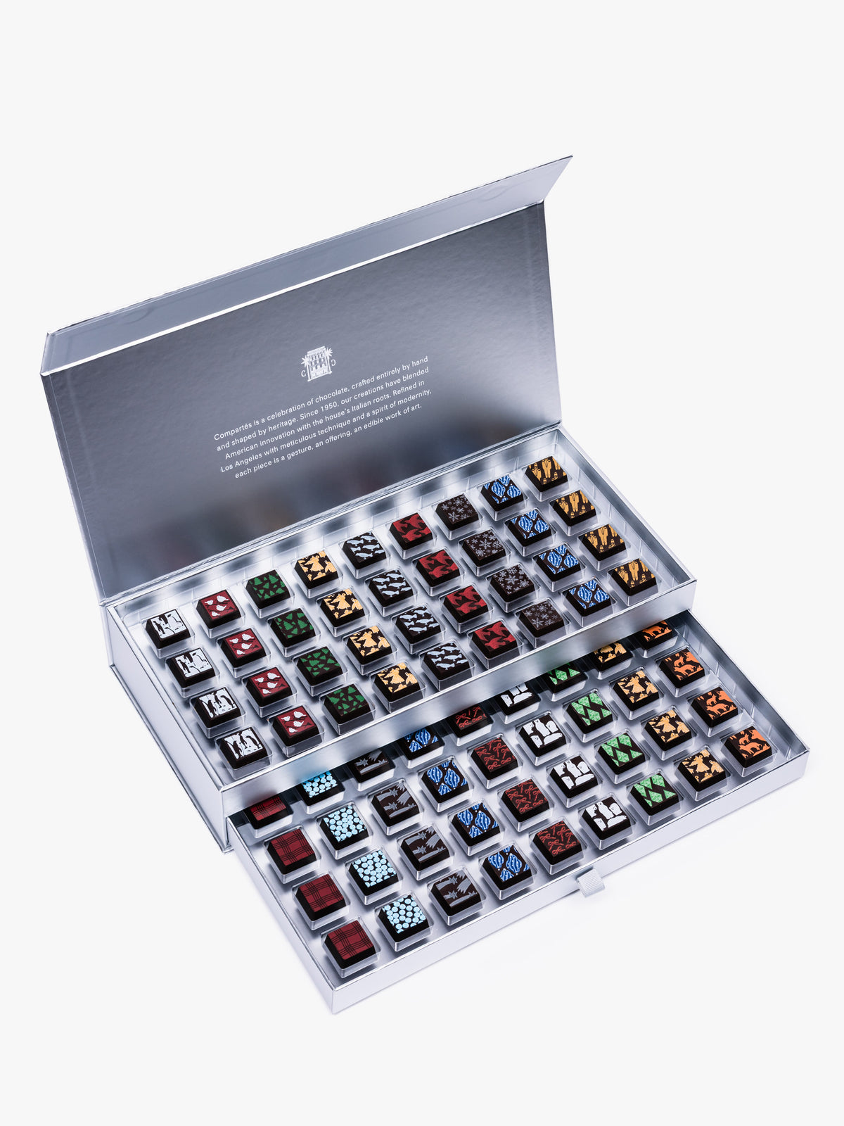 Compartes Silver Holiday Drawer Collection featuring 80 handcrafted holiday chocolates in a metallic silver gift box with seasonal designs.