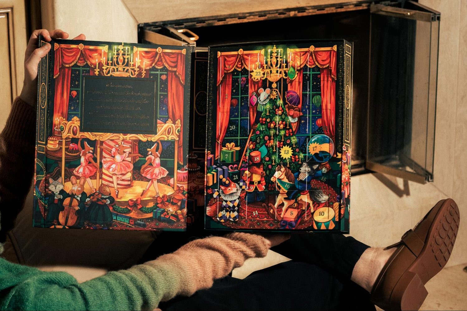 Man sitting with leg up holding opened advent calendar by Compartés