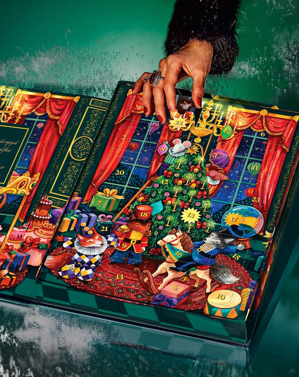 Person taking chocolate truffle from advent calendar