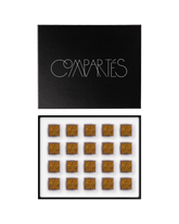Compartes luxury champagne chocolate truffles in a black gift box, squares in deep gold swirl patterns