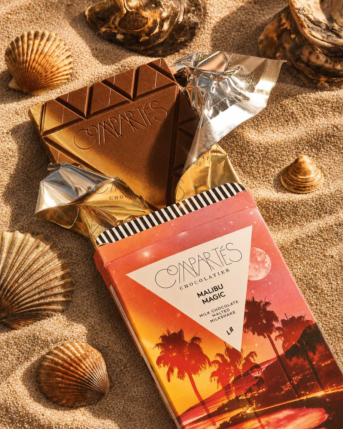 Gourmet Milk Chocolate Bar by Compartes Los Angeles filled with premium milk chocolate sea salt malt balls and malted milk in a gorgeous California sandscape.