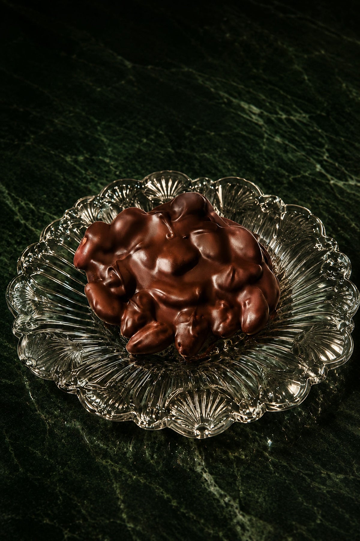 Vegan Dark Chocolate Almonds Bark Handmade in Los Angeles by Compartes Chocolates on a glass plate.