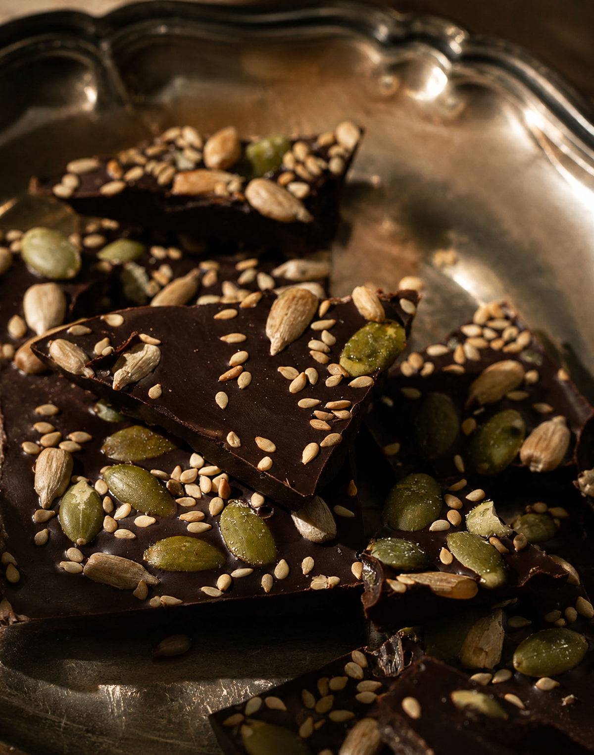 Vegan Dark Chocolate Gourmet Chocolate Bar with nuts and seeds in a silver tray by Compartes Chocolatiers Los Angeles. 