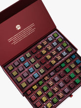 Compartes Burgundy Signature Drawer Collection featuring 80 handcrafted chocolates in a burgundy box with gold foil and geometric designs.
