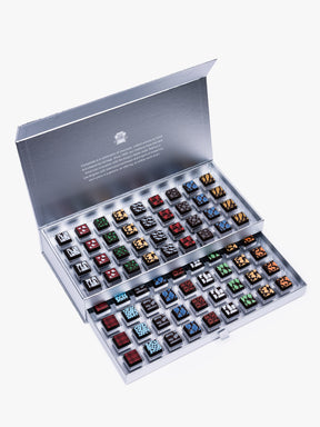Compartes Silver Holiday Drawer Collection featuring 80 handcrafted holiday chocolates in a metallic silver gift box with seasonal designs.