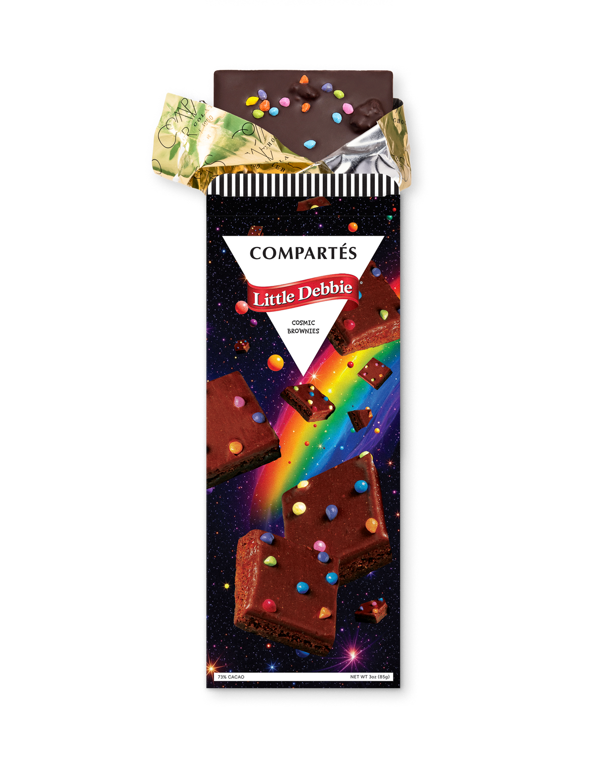 A Compétés Little Debbie cosmic brownies chocolate bar in its wrapper, with the gold foil wrapper partially peeled back at the top. The wrapper features a colorful design with brownies, and a rainbow on a starry space background.